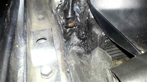 Remove shifter assembly, place the nylon strap to the side. . 2015 jeep grand cherokee water leak driver side